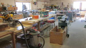 Miscellaneous room featuring unfinished concrete floors and a workshop area