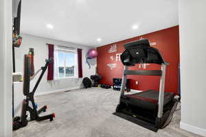 Workout area with carpet flooring and recessed lighting