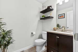 Half bathroom featuring vanity and light wood finished floors