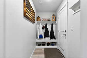 Mudroom featuring light wood-type flooring and baseboards