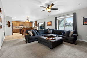 Living area with recessed lighting, a ceiling fan, and light colored carpet