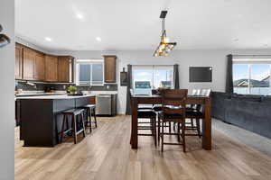 Dining room featuring plenty of natural light, light wood finished floors, and recessed lighting