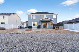 Rear view of house with a fenced backyard, a patio, and stucco siding