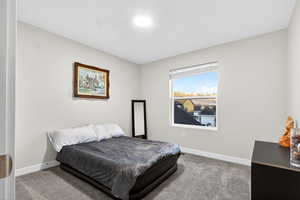 Carpeted bedroom with baseboards