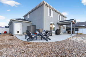 Rear view of property featuring a patio area and stucco siding