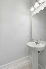 Bathroom featuring light tile patterned floors and baseboards