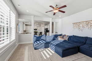 Living area featuring light colored carpet, recessed lighting, and a ceiling fan