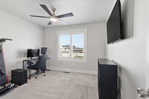 Office area featuring light carpet and a ceiling fan