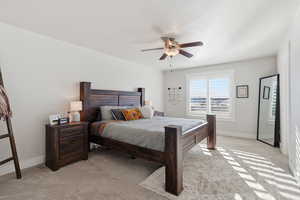 Bedroom featuring light colored carpet and a ceiling fan