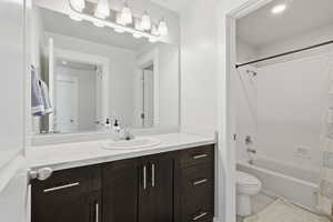 Bathroom with vanity, shower / bath combo with shower curtain, and light tile patterned floors