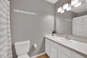 Bathroom featuring a shower with curtain and vanity