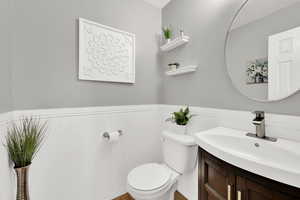 Half bath with vanity and wainscoting