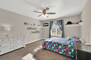 Bedroom featuring carpet and a ceiling fan
