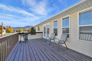 Deck with a grill and a mountain view