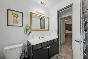 Bathroom featuring vanity and light carpet