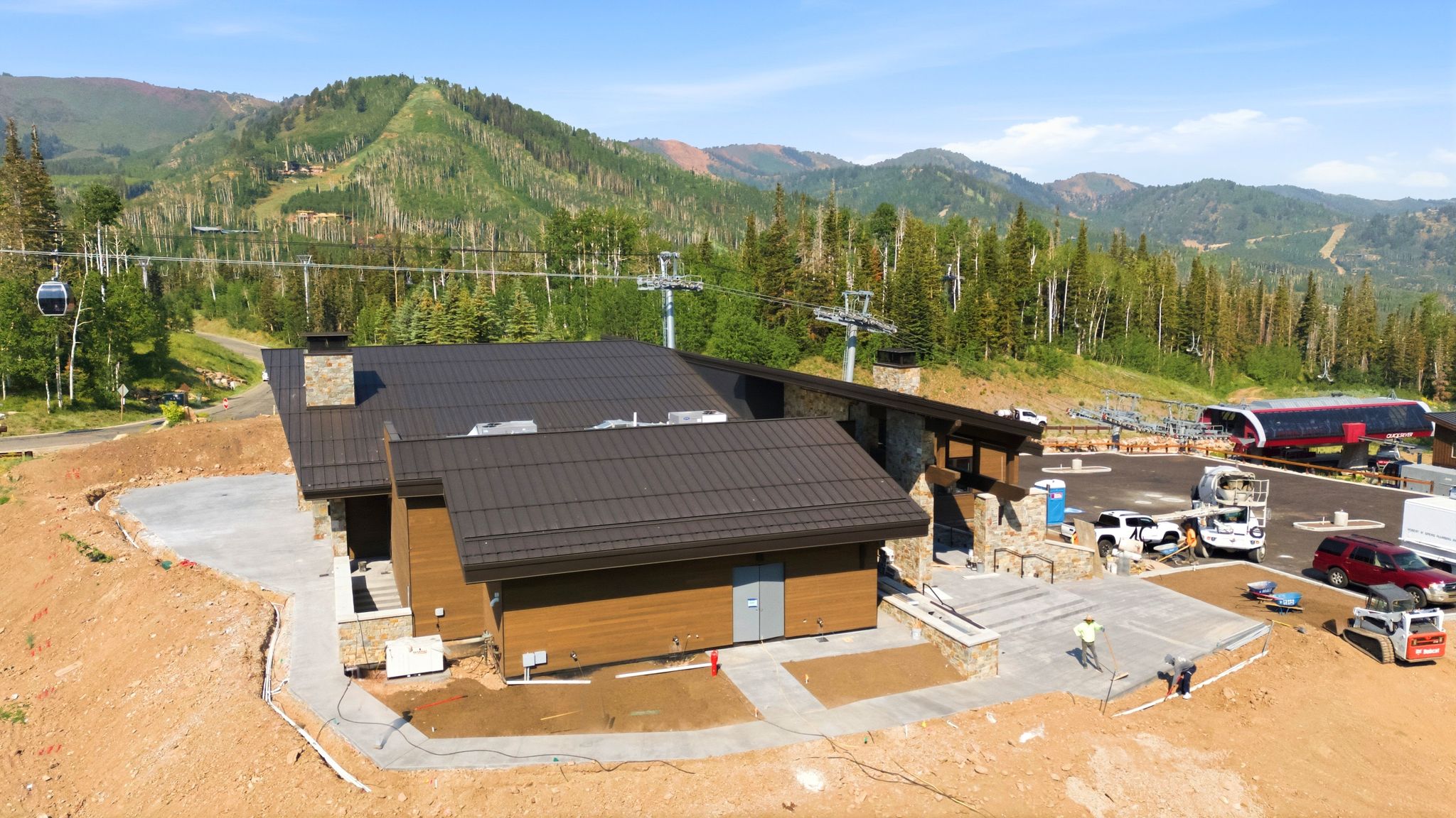 Modern mountain-style structure featuring a metal roof and stone accents
