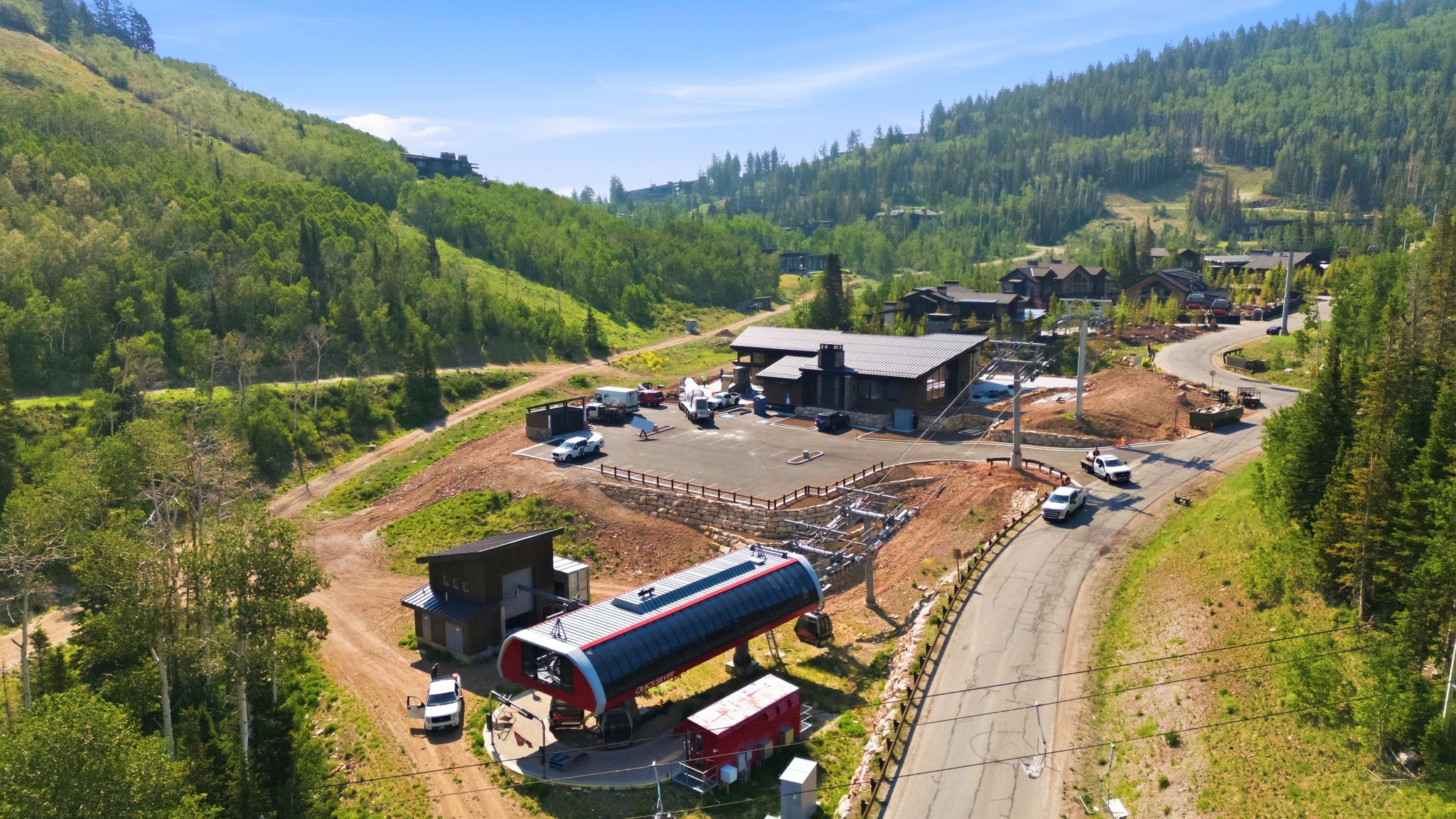 Ski lift station with surrounding wooded hillsides and partially paved roads