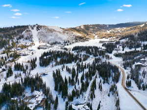 Snowy aerial view featuring a mountain view