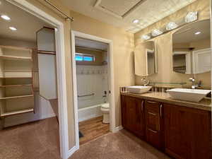 Primary bedroom's full bathroom complete with double sinks, generously sized closet and laundry area