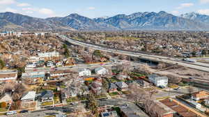 Aerial view of residential area featuring mountains and a major roadway