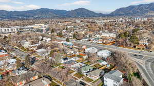Aerial overview of property's location with mountains and nearby suburban area