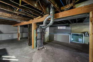 Below grade area with strapped water heater and heating unit