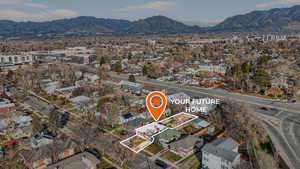 Aerial overview of property's location with mountains and nearby suburban area