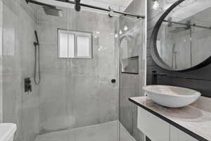 Full bathroom featuring vanity and a shower stall