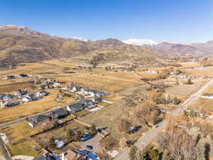 Aerial view of sparsely populated area featuring nearby suburban area and mountains