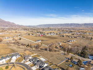View of rural area featuring nearby suburban area and a mountainous background