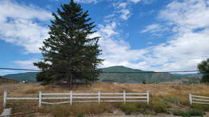 View of mountain backdrop featuring rural landscape