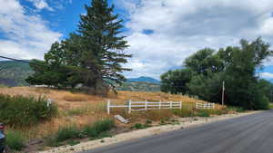 View of asphalt road featuring a mountain view and a rural view