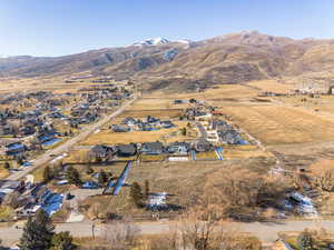 Aerial overview of property's location with nearby suburban area and mountains
