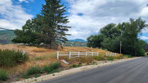 View of asphalt road with a mountain view and a view of countryside