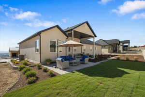 Enhanced exterior photo staged, (Landscaping not included) Rear view of house featuring outdoor furniture, a patio, and a yard
