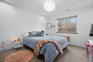 Bedroom featuring carpet and a chandelier