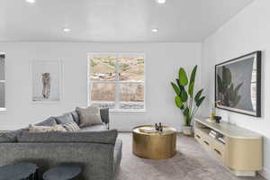 Carpeted living area with recessed lighting