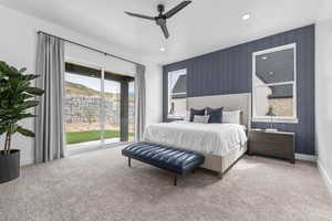 Bedroom with an accent wall, wallpapered walls, light colored carpet, access to exterior, and ceiling fan