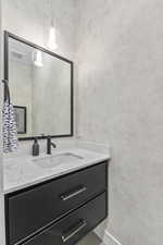 Bathroom with vanity and baseboards