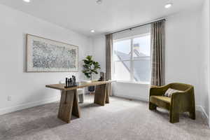 Carpeted office space featuring baseboards and recessed lighting