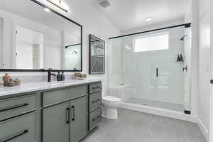 Full bath featuring vanity and a stall shower
