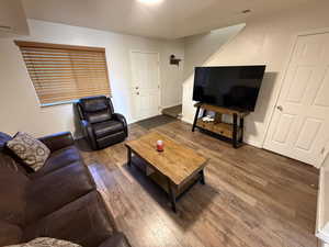 Living room featuring hardwood / wood-style floors and stairway