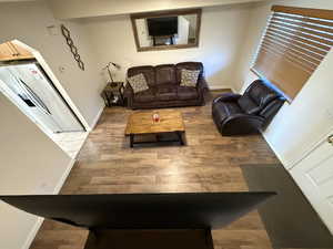 Living room with baseboards and light wood-style floors
