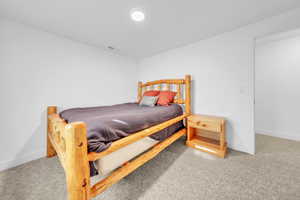 Bedroom with light colored carpet