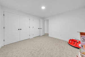 Game room with baseboards and carpet