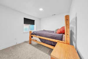 Carpeted bedroom with baseboards