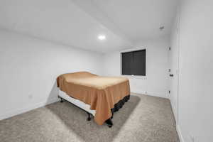 Bedroom featuring light carpet and recessed lighting