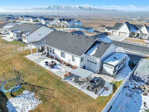 Snowy aerial view with a residential view and a mountain view