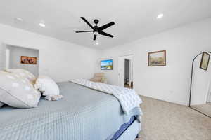 Bedroom with ceiling fan, light carpet, and recessed lighting