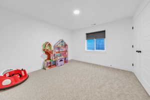 Game room with baseboards and carpet flooring